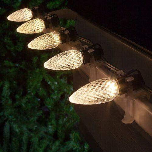 Warm-white faceted C9 LED bulb on green wire, the commercial-grade product Holiday House installs